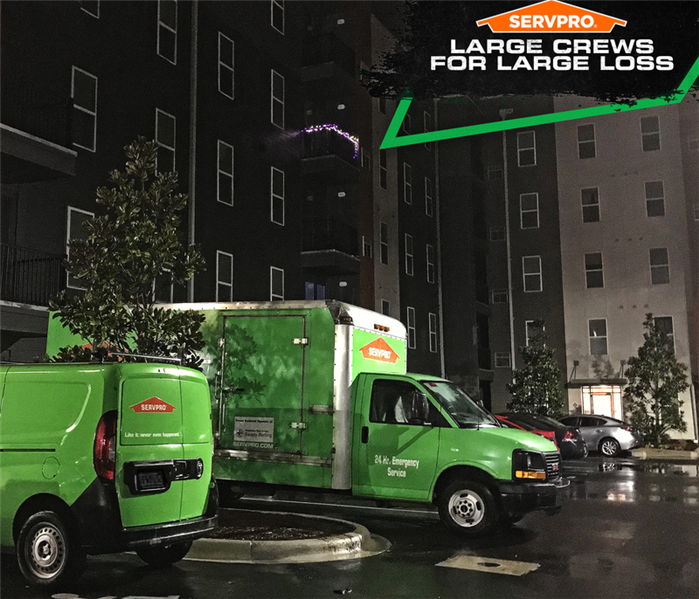 Two SERVPRO trucks in front of a building with cation: "LARGE CREWS FOR LARGE LOSS" 